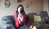 Sucking a long candy while playing with her boobs